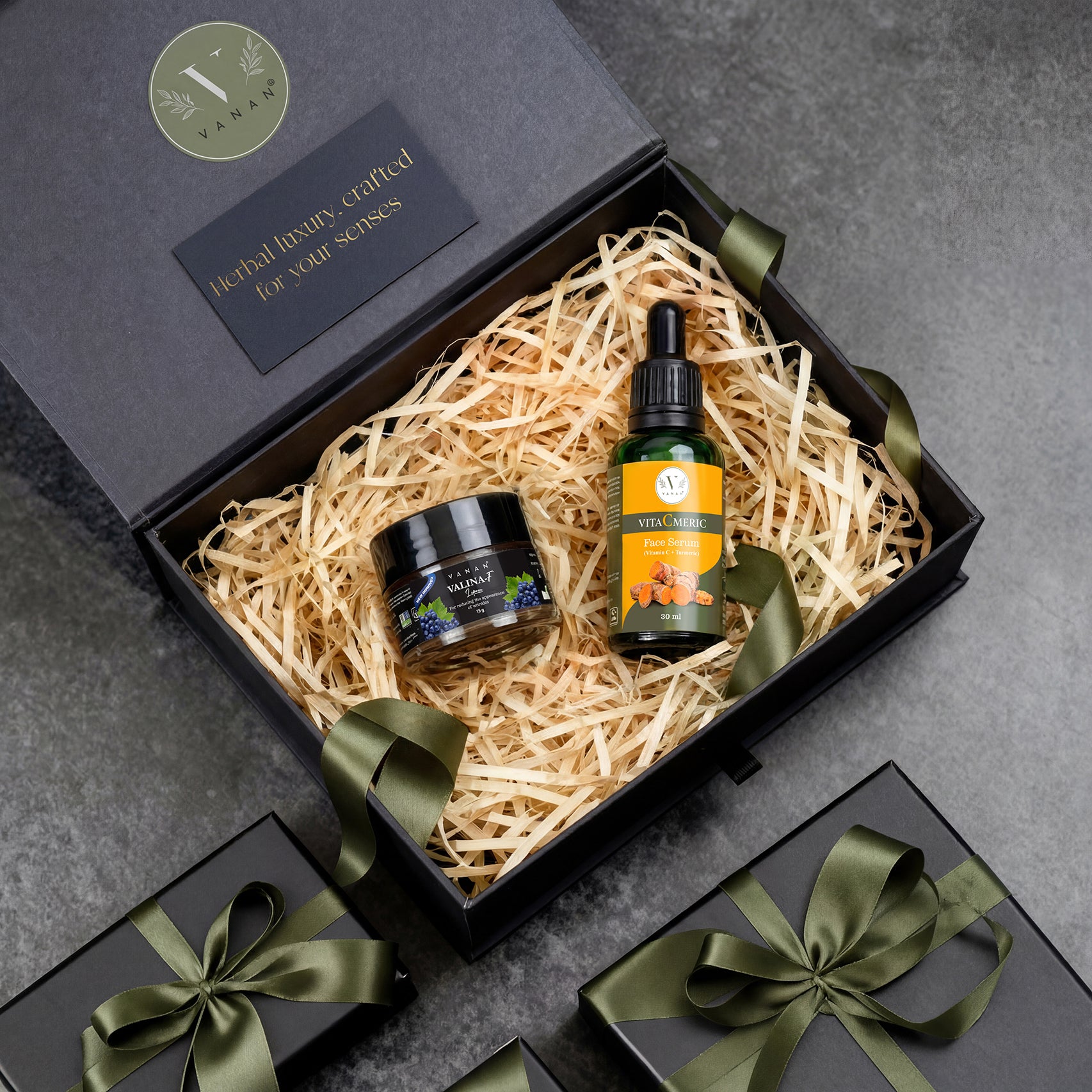 Gift set with two products in a black box on a gray surface