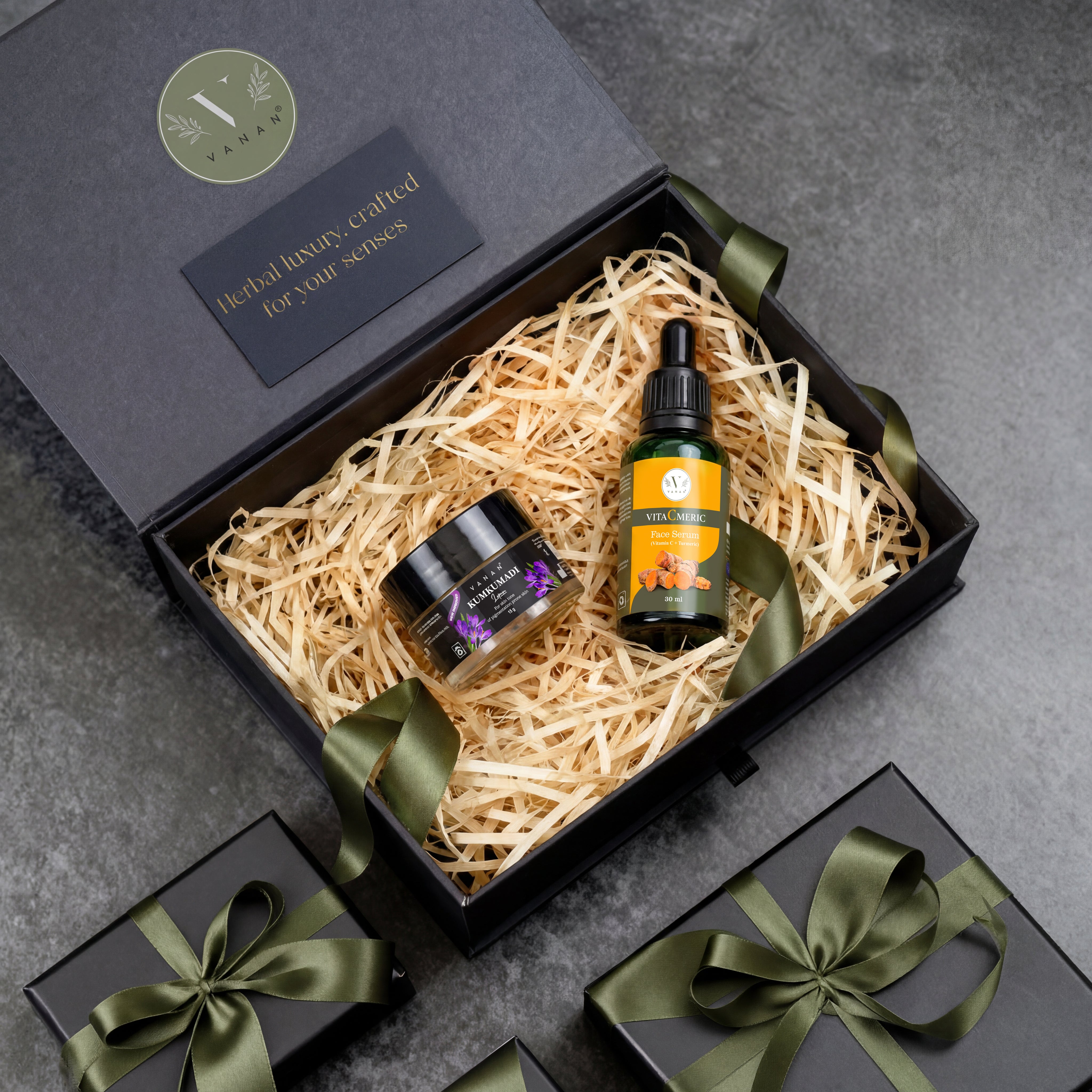 Gift set with a bottle and jar in a decorative box on a gray surface