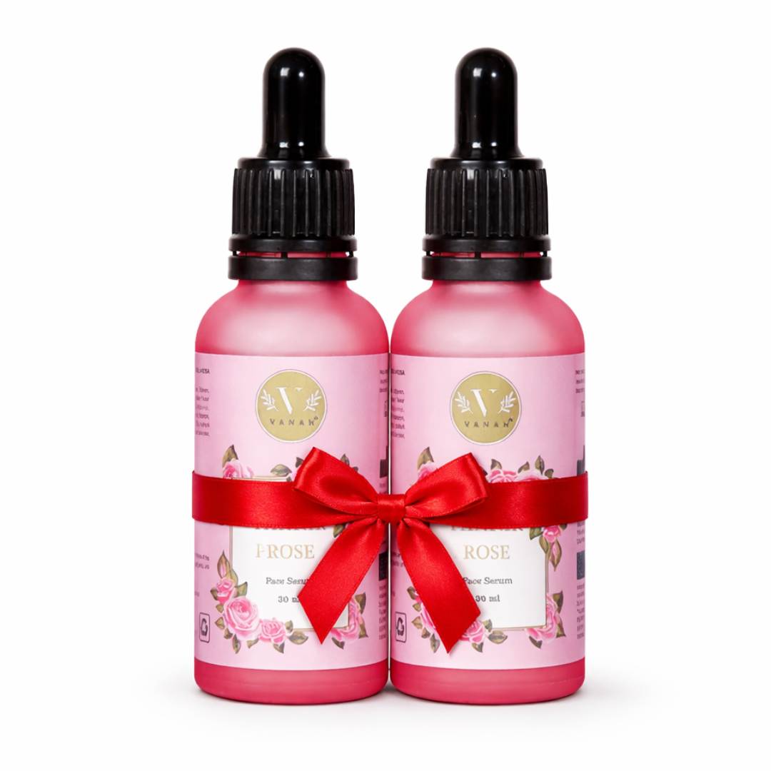 Two pink bottles with droppers and a red bow on a white background